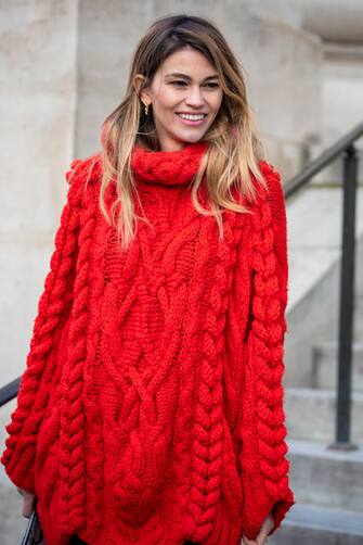 PARIS, FRANCE - JANUARY 19: A guest, wearing a long red knitted jumper, is seen in the streets of Paris after the Sacai show on January 19, 2019 in Paris, France. (Photo by Claudio Lavenia/Getty Images)