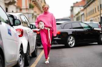 MILAN, ITALY - SEPTEMBER 22:  Leonie Hanne wears pink sunglasses, a pink wool turtleneck pullover, a white bag, a white belt, pink pants, white sandals, outside the Boss show during Milan Fashion Week Spring/Summer 2020 on September 22, 2019 in Milan, Italy. (Photo by Edward Berthelot/Getty Images)