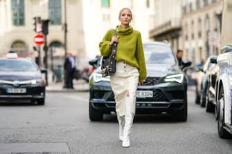 PARIS, FRANCE - SEPTEMBER 30: Leonie Hanne wears a green wool turtleneck knitted pullover, a Givenchy bag, white side slit skirt, white high boots, outside Beautiful People, during Paris Fashion Week - Womenswear Spring Summer 2020, on September 30, 2019 in Paris, France. (Photo by Edward Berthelot/Getty Images)