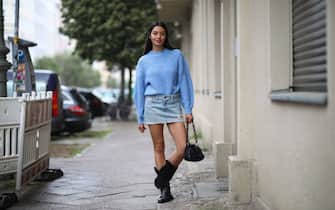 BERLIN, GERMANY - MAY 05: Alyssa Cordes wearing Levis jeans skirt, blue sweater, vintage cowboy boots and Fabienne Chapot bag on May 05, 2020 in Berlin, Germany. (Photo by Jeremy Moeller/Getty Images)