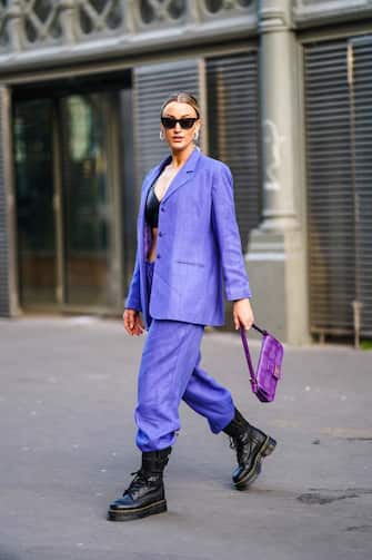 PARIS, FRANCE - JANUARY 20: Noor de Groot wears sunglasses, earrings, a black leather bra top, a mauve jacket, matched pants, black army-style boots, a purple Fendi handbag, outside Ralph & Russo, during Paris Fashion Week - Haute Couture Spring/Summer 2020, on January 20, 2020 in Paris, France. (Photo by Edward Berthelot/Getty Images )