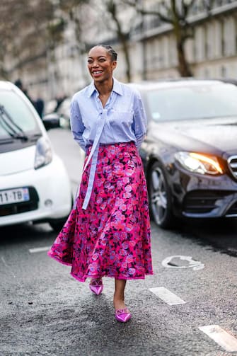PARIS, FRANCE - MARCH 01: Actress Naomi Ackie wears a mauve shirt, a red and pink floral print skirt, pink pointy Valentino shoes, outside Valentino, during Paris Fashion Week - Womenswear Fall/Winter 2020/2021, on March 01, 2020 in Paris, France. (Photo by Edward Berthelot/Getty Images)