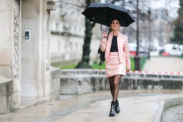 PARIS, FRANCE - MARCH 04: Negin Mirsalehi, fashion blogger, wears a black top, a pink jacket, a pink skirt, black tights, and black leather boots, outside the Elie Saab show, during Paris Fashion Week Womenswear Fall/Winter 2017/2018, on March 4, 2017 in Paris, France. (Photo by Edward Berthelot/Getty Images)