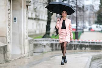 PARIS, FRANCE - MARCH 04:  Negin Mirsalehi, fashion blogger, wears a black top, a pink jacket, a pink skirt, black tights, and black leather boots, outside the Elie Saab show, during Paris Fashion Week Womenswear Fall/Winter 2017/2018, on March 4, 2017 in Paris, France.  (Photo by Edward Berthelot/Getty Images)