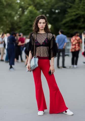 PARIS, FRANCE - JULY 04: Model Mckenna Hellam wearing sheer top, red flared pants outside Alexandre Vauthier during Paris Fashion Week - Haute Couture Fall / Winter 2017-2018: Day Three on July 4, 2017 in Paris, France.  (Photo by Christian Vierig / Getty Images)