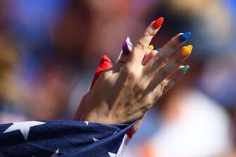 A USA fan with painted fingernails cheers prior to the France 2019 Womens World Cup football final match between USA and the Netherlands, on July 7, 2019, at the Lyon Stadium in Lyon, central-eastern France. (Photo by FRANCK FIFE / AFP)        (Photo credit should read FRANCK FIFE/AFP via Getty Images)