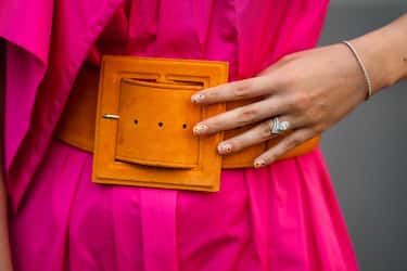 PARIS, FRANCE - AUGUST 02: Gabriella Berdugo wears a Fuchsia neon pink nylon dress, an orange maxi belt from Natan, finger rings and jewelry, fantasy nail polish, on August 02, 2021 in Paris, France. (Photo by Edward Berthelot/Getty Images)