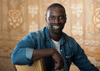 TO GO WITH AFP STORY BY Michael THURSTON, Entertainment-US-France-film-Samba-Sy
French actor Omar Sy poses during the press day for the movie "Samba", in Beverly Hills, California, on July 20, 2015. Sy has come a long way from the gritty Paris suburbs where he grew up. But sitting in a five-star Beverly Hills hotel he has clearly not forgotten his immigrant roots. And the same goes for his career -- weeks after starring in the record-breaking "Jurassic World" blockbuster franchise, he will be on US cinema screens in his latest French film, "Samba."  AFP PHOTO/VALERIE MACON        (Photo credit should read VALERIE MACON/AFP via Getty Images)