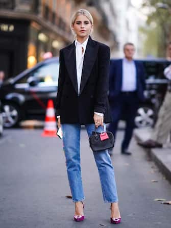 PARIS, FRANCE - SEPTEMBER 28: Caroline Daur wears a white shirt, a black blazer jacket, a bag with an attached pink mini bag, blue cropped jeans, purple shoes, outside Ralph Lauren, during Paris Fashion Week - Womenswear Spring Summer 2020 on September 28, 2019 in Paris, France. (Photo by Edward Berthelot/Getty Images)