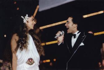 The italian singer Al Bano, born Albano Carrisi, and his wife, the american singer Romina Power, smile and sing the stage of Sanremo Music Festival. The couple won the Festival with their song " Ci sarÃ ". Sanremo, Italy, 1984. (Photo by Mondadori via Getty Images)