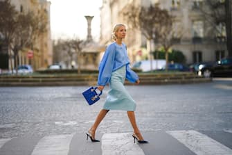 PARIS, FRANCE - JANUARY 21: Leonie Hanne wears a blue silky lustous blouse with puff sleeves, a blue quilted Lady Dior bag, a pale blue leather skirt, Dior pointy shoes, during Paris Fashion Week - Haute Couture Spring/Summer 2020, on January 21, 2020 in Paris, France. (Photo by Edward Berthelot/Getty Images )