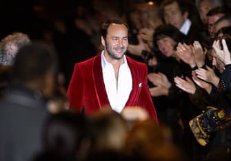 PARIS, FRANCE:  US designer Tom Ford greets the crowd at the end of his final show for Yves Saint-Laurent during the presentation of Autumn/Winter 2004-05 collections at the Paris fashion week 07 March 2004.       AFP MARTIN BUREAU  (Photo credit should read MARTIN BUREAU/AFP via Getty Images)