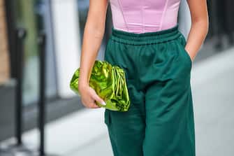 NEW YORK, NEW YORK - SEPTEMBER 10: Valentina Ferragni wears a pale pink silk square-neck / cropped corset top, a gold watch, a shiny green metallic leather puffy handbag from Bottega Veneta, dark green cotton cargo sport pants, outside Tibi , during New York Fashion Week, on September 10, 2022 in New York City.  (Photo by Edward Berthelot/Getty Images)