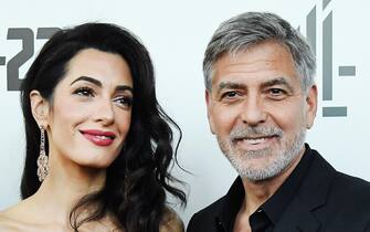 epa09167186 (FILE) - US actor and director George Clooney (R) with his wife Lebanese-British barrister Amal Clooney (L) arrive for the premiere of 'Catch 22' in London, Britain, 15 May 2019 (reissued 29 April 2021). George Clooney turns 60 on 06 May 2021.  EPA/ANDY RAIN