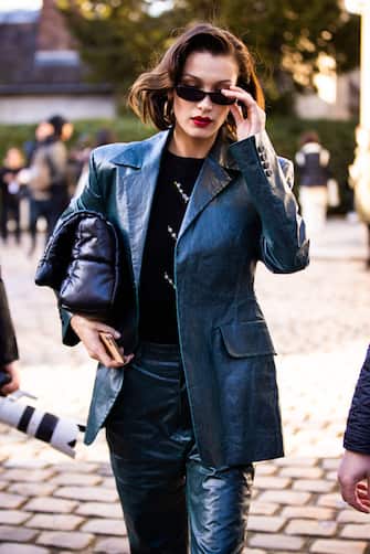 PARIS, FRANCE - FEBRUARY 26: Bella Hadid, wearing a green leather suit, is seen outside Lanvin, during Paris Fashion Week - Womenswear Fall/Winter 2020/2021 : Day Three on February 26, 2020 in Paris, France. (Photo by Claudio Lavenia/Getty Images)