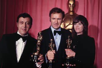 (Original Caption) Los Angeles, Calif,: Philip D' Antoni (left) and Gene Hackman, producer and star, respectively, of "best picture" The French Connection, hold Oscars they won-Hackman's for "best actor" at the 44th movie academy awards ceremony. Standing with them is Jane Fonda, who won "best actress" award for the movie Klute.