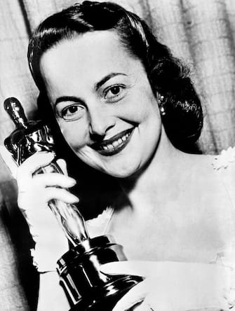 US actress Olivia de Havilland poses on March 27, 1950 with her Oscar for Best Actress in a Leading Role for the  drama film "The Heiress" in Hollywood. (Photo by - / INTERCONTINENTALE / AFP) (Photo by -/INTERCONTINENTALE/AFP via Getty Images)