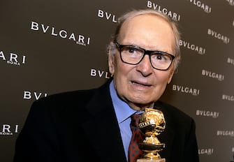 Italian orchestrator and conductor, Ennio Morricone poses with the 2016 Golden Globe for Best Original Score for Quentin Tarantinos hit movie "The Hateful Eight" during a press conference at Bulgari Domus in central Rome on January 30, 2016.  
One of the highlights of the Golden Globe handing over ceremony was the announcement of Bulgaris support of The Glance of Music, a documentary Tornatore is in the process of filming as a tribute to Morricone, a pillar of the world of music as well as his friend and long time cinematic and musical collaborator of almost 25 years. / AFP / FILIPPO MONTEFORTE        (Photo credit should read FILIPPO MONTEFORTE/AFP via Getty Images)