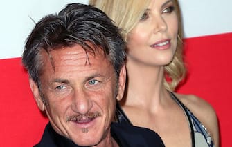 LOS ANGELES, CA - MARCH 12:  Actor Sean Penn (L) and actress Charlize Theron attend the premiere of Open Road Films' "The Gunman" at Regal Cinemas L.A. Live on March 12, 2015 in Los Angeles, California.  (Photo by David Livingston/Getty Images)