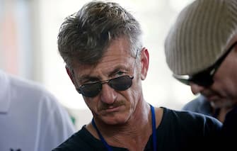 Actor Sean Penn (C) tours the Lime Nursery and Grafting Project in Mirebalais, in the central plateau of Haiti, on February 23, 2015. AFP PHOTO/HECTOR RETAMAL         (Photo credit should read HECTOR RETAMAL/AFP via Getty Images)