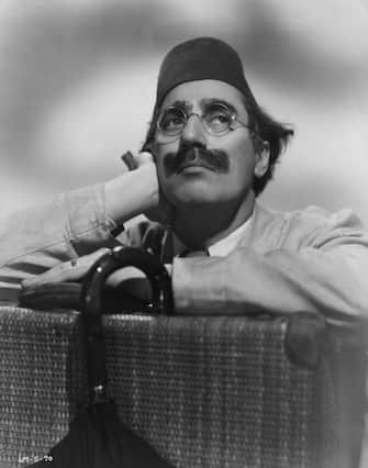 circa 1935:  Julius 'Groucho' Marx (1895 - 1977), one of the Marx Brothers, a team of American film comedians. He is wearing a fez for his role in 'A Night In Casablanca', a David L Loew production.  (Photo by Hulton Archive/Getty Images)
