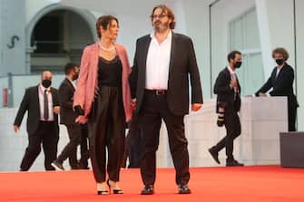 VENICE, ITALY - SEPTEMBER 09: A guest and Giuseppe Battiston walk the red carpet ahead of the movie "Le Sorelle Macaluso" at the 77th Venice Film Festival on September 09, 2020 in Venice, Italy. (Photo by Elisabetta Villa/Getty Images)