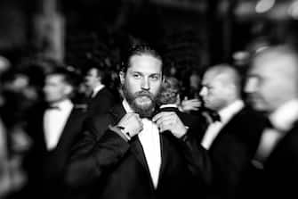 CANNES, FRANCE - MAY 19:  (EDITORS NOTE: This image was produced using a lens baby selective focus lens. Image has been converted to black and white. This image has been altered digitally to apply texture) Actor Tom Hardy departs the 'Lawless' Premiere during the 65th Annual Cannes Film Festival at Palais des Festivals on May 19, 2012 in Cannes, France.  (Photo by Gareth Cattermole/Getty Images)