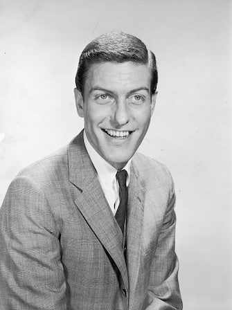 1958:  Portrait of American comedian and actor Dick van Dyke smiling in a suit and tie.  (Photo by Hulton Archive/Getty Images)