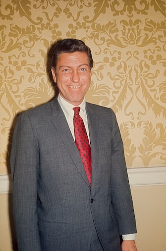 Dick Van Dyke posing for the photographer  wearing a gray suit and red tie; circa 1970; New York. (Photo by Art Zelin/Getty Images)