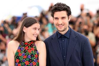 French actress Laetitia Casta (L) Fench actor and director Louis Garrel smile during a photocall for the film "La Croisade" at the 74th edition of the Cannes Film Festival in Cannes, southern France, on July 12, 2021. (Photo by Valery HACHE / AFP) (Photo by VALERY HACHE/AFP via Getty Images)