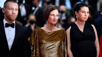 French actress Camille Cottin (C) and director Rachel Lang (R) arrive for the screening of the film "Mon Legionnaire" at the 74th edition of the Cannes Film Festival in Cannes, southern France, on July 15, 2021. (Photo by John MACDOUGALL / AFP) (Photo by JOHN MACDOUGALL/AFP via Getty Images)