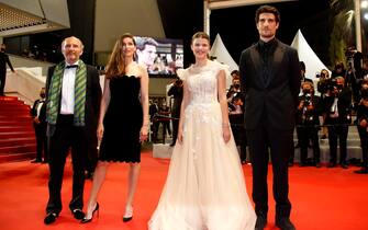 epa09341145 (L-R) Gregoire Hetzel, Laetitia Casta, Julia Boeme, and Louis Garrel arrive for the screening of 'Bac Nord' during the 74th annual Cannes Film Festival, in Cannes, France, 12 July 2021. The movie is presented Out of Official Competition at the festival which runs from 06 to 17 July.  EPA/Sebastien Nogier