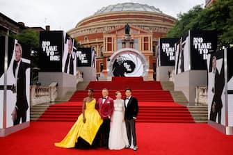 English actor Lashana Lynch (L), English actor Daniel Craig (C) and French actor Lea Seydoux (2R) and US film director Cary Joji Fukunaga pose on the red carpet after arriving to attend the World Premiere of the James Bond 007 film "No Time to Die" at the Royal Albert Hall in west London on September 28, 2021. - Celebrities and royals walk the red carpet in central London on Tuesday for the star-studded but much-delayed world premiere of the latest James Bond film, "No Time To Die". (Photo by Tolga Akmen / AFP) (Photo by TOLGA AKMEN/AFP via Getty Images)
