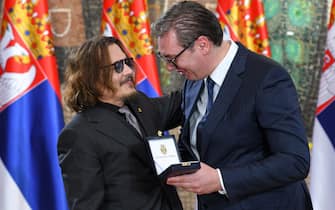 Johnny Depp receives medal of honor from controversial Serbian president.  PHOTO