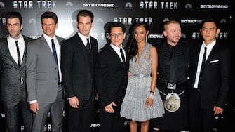 (Left to right) Eric Bana, Zachary Quinto, Karl Urban, Chris Pine, JJ Abrams, Zoe Saldana, Simon Pegg and John Cho pose for photographs as they arrive for the UK Film Premiere of Star Trek at the Empire Leicester Square, London.   (Photo by Ian West - PA Images/PA Images via Getty Images)