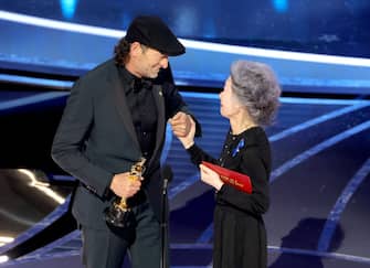 HOLLYWOOD, CALIFORNIA - MARCH 27: (L-R) Troy Kotsur accepts the Actor in a Supporting Role award for â  CODAâ   from Youn Yuh-jung onstage during the 94th Annual Academy Awards at Dolby Theatre on March 27, 2022 in Hollywood, California. (Photo by Neilson Barnard/Getty Images)