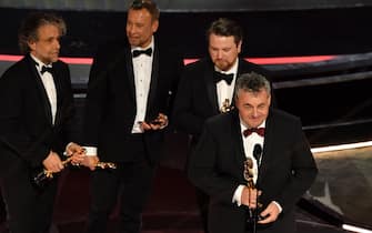 "Dune" visual effects team Paul Lambert (L), Tristan Myles (2nd R), Brian Connor (2nd L) and Gerd Nefzer (R) accept the award for Best Visual Effects for "Dune" onstage during the 94th Oscars at the Dolby Theatre in Hollywood, California on March 27, 2022. (Photo by Robyn Beck / AFP) (Photo by ROBYN BECK/AFP via Getty Images)