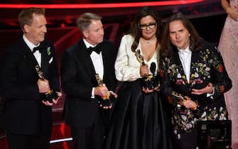 Jared Bush (L), Byron Howard (R), Yvett Merino (2nd R) and Clark Spencer (2nd L) accept the award for Best animated feature film for "Encanto"  onstage during the 94th Oscars at the Dolby Theatre in Hollywood, California on March 27, 2022. (Photo by Robyn Beck / AFP) (Photo by ROBYN BECK/AFP via Getty Images)