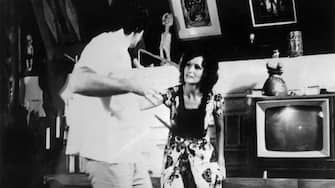 (Original Caption) Linda Lovelace, actress, is shown in doctor's office in the porno movie, Deep Throat with actor Harry Reems.