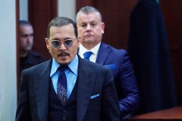 US actor Johnny Depp walks into the courtroom after a break at the Fairfax County Circuit Court in Fairfax, Virginia, on May 2, 2022. - Actor Johnny Depp sued his ex-wife Amber Heard for libel in Fairfax County Circuit Court after she wrote an op-ed piece in The Washington Post in 2018 referring to herself as a "public figure representing domestic abuse." (Photo by Steve Helber / POOL / AFP) (Photo by STEVE HELBER/POOL/AFP via Getty Images)