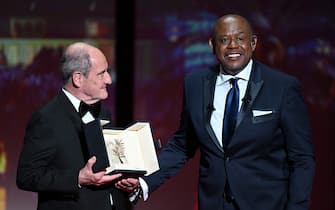 US actor Forest Whitaker (R) smiles next to the President of the Cannes Film Festival Pierre Lescure after he was awarded with an Honorary Palm D'Or during the Opening Ceremony of the 75th edition of the Cannes Film Festival in Cannes, southern France, on May 17, 2022. (Photo by CHRISTOPHE SIMON / AFP) (Photo by CHRISTOPHE SIMON/AFP via Getty Images)