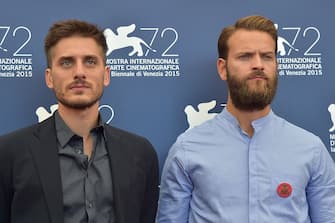 Actor Luca Marinelli (L) and actor Alessandro Borghi pose during the photocall of the movie "Non Essere Cattivo" presented out of competition at the 72nd Venice International Film Festival on September 7, 2015 at Venice Lido.  AFP PHOTO / GIUSEPPE CACACE        (Photo credit should read GIUSEPPE CACACE/AFP via Getty Images)