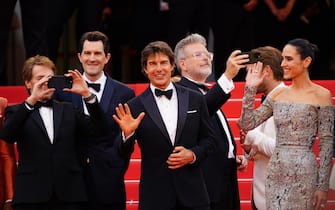epa09955895 (L-R) Producer Jerry Bruckenheimer, actors Tom Cruise and Jennifer Connelly arrive for the screening of 'Top Gun: Maverick' during the 75th annual Cannes Film Festival, in Cannes, France, 18 May 2022. The movie is presented out of competition of the festival which runs from 17 to 28 May.  EPA/CLEMENS BILAN