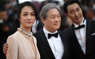 (From L) Chinese actress Tang Wei, South Korean producer Park Chan-Wook and South Korean actor Park Hae-Il arrive for the screening of the film "Decision to Leave (Heojil Kyolshim)" during the 75th edition of the Cannes Film Festival in Cannes, southern France, on May 23, 2022. (Photo by LOIC VENANCE / AFP) (Photo by LOIC VENANCE/AFP via Getty Images)