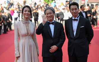 (From L) Chinese actress Tang Wei, South Korean director Park Chan-Wook and South Korean actor Park Hae-Il arrive for the screening of the film "Decision to Leave (Heojil Kyolshim)" during the 75th edition of the Cannes Film Festival in Cannes, southern France, on May 23, 2022. (Photo by CHRISTOPHE SIMON / AFP) (Photo by CHRISTOPHE SIMON/AFP via Getty Images)