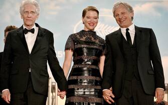(FromL) Canadian film director David Cronenberg, French actress Lea Seydoux and US actor Viggo Mortensen pose before leaving the Festival Palace after the screening of the film "Crimes Of the Future" during the 75th edition of the Cannes Film Festival in Cannes, southern France, on May 23, 2022. (Photo by LOIC VENANCE / AFP) (Photo by LOIC VENANCE/AFP via Getty Images)