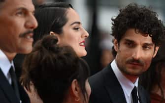 French actress Noemie Merlant (C) and French actor and director Louis Garrel (R) arrive for the screening of the film "The Innocent (L'Innocent)" during the 75th edition of the Cannes Film Festival in Cannes, southern France, on May 24, 2022. (Photo by PATRICIA DE MELO MOREIRA / AFP) (Photo by PATRICIA DE MELO MOREIRA/AFP via Getty Images)