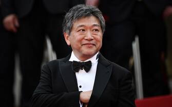 Japanese film director, producer, screenplay writer and film editor Hirokazu Kore-Eda arrives for the screening of the film "Broker" during the 75th edition of the Cannes Film Festival in Cannes, southern France, on May 26, 2022. (Photo by LOIC VENANCE / AFP) (Photo by LOIC VENANCE/AFP via Getty Images)