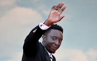 TOPSHOT - French actor Ahmed Sylla waves as he arrives for the screening of the film "Mother And Son (Un Petit Frere)" during the 75th edition of the Cannes Film Festival in Cannes, southern France, on May 27, 2022. (Photo by LOIC VENANCE / AFP) (Photo by LOIC VENANCE/AFP via Getty Images)