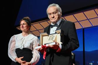 CANNES, FRANCE - MAY 28: Director Jerzy Skolimowski (R) receive from Alice Rohrwacher (L), ex-aequo the Jury Prize for the movie 'Eo' during the closing ceremony for the 75th annual Cannes film festival at Palais des Festivals on May 28, 2022 in Cannes, France. (Photo by Stephane Cardinale - Corbis/Corbis via Getty Images)